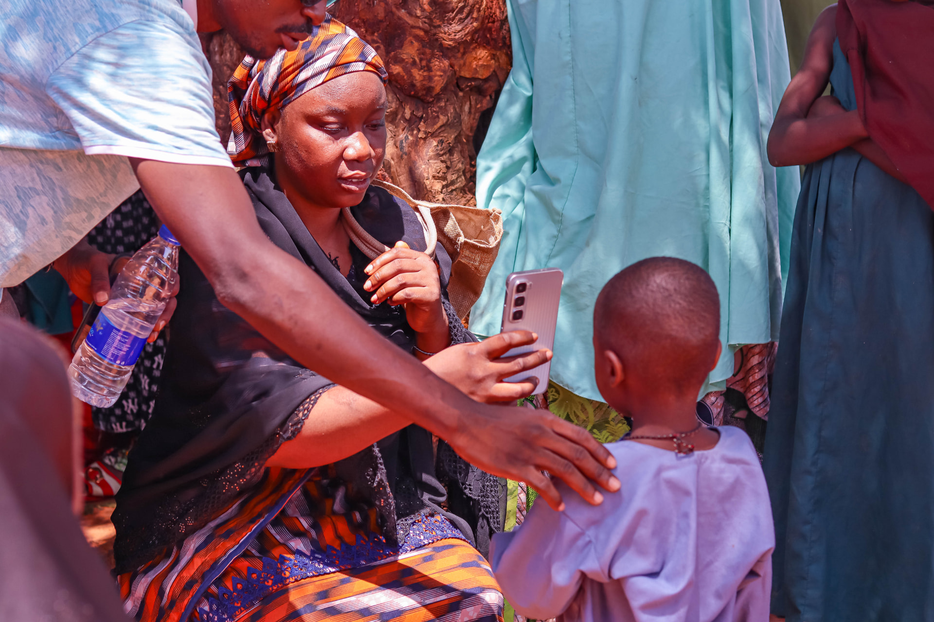 A C-Tracka field worker enrolling a child using a mobile phone